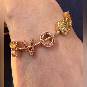 702. “LOVE” Gold Tone and Pink Crystals With Medusa Charm Bracelet